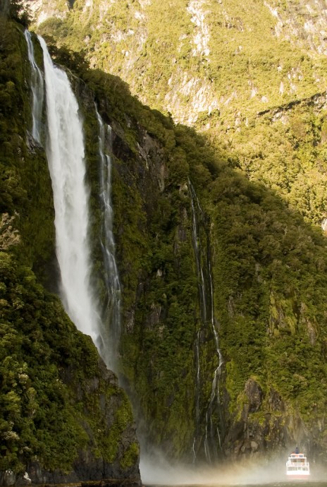 Stirling Falls in New Zealand with tour boat for scale