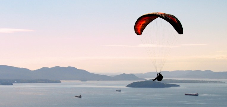 A paraglider enjoys a view of the San Juan Islands