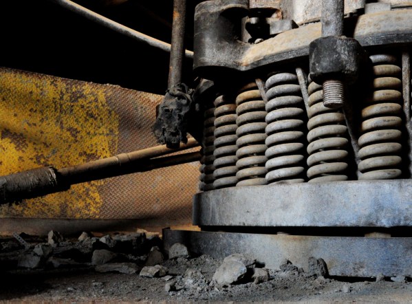 Debris lies on the ground around one of the ore crushing devices