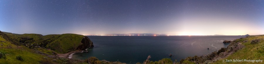 A panorama of the California coastline showing many large light domes degrading the view of the night sky. 