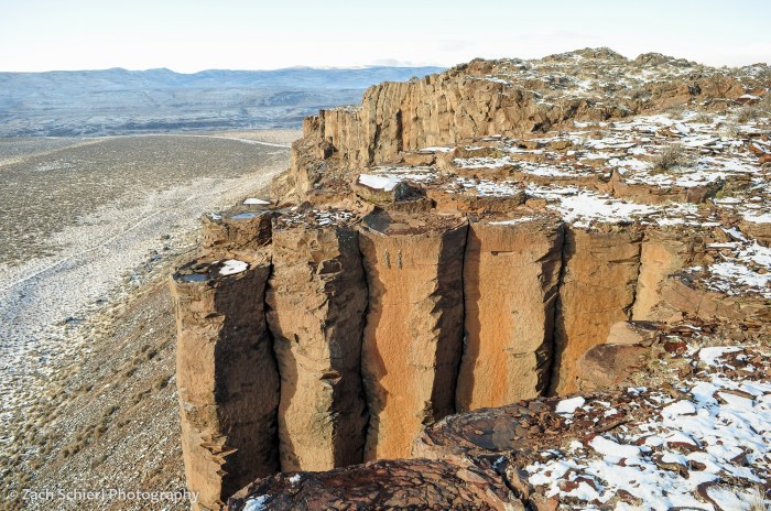 A cliff of basalt with patches of snow
