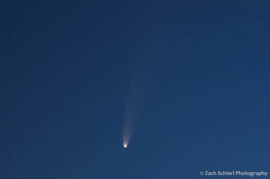 Close-up view of a comet with a bright nucleus and a two-pronged tail