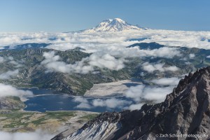 View of a volcanic peak with a blue lake in the foreground