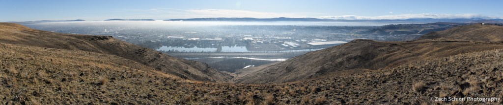 A thin layer of fog and pollution sits in broad valley.